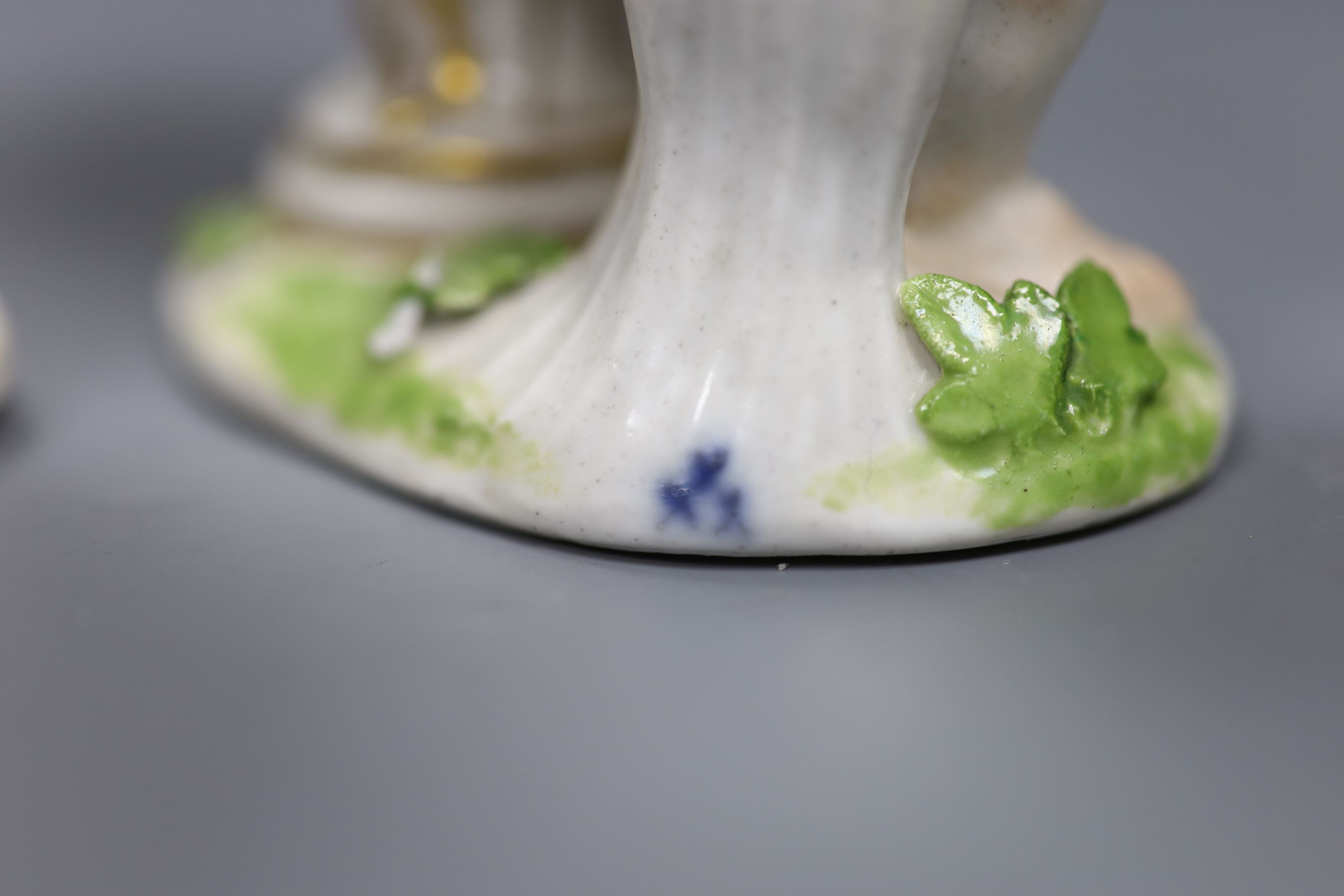 A pair of 18th century Meissen figures of putti and vases, height 14cm